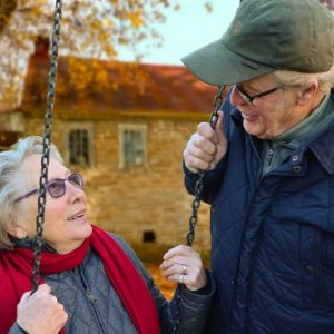 Elderly couple spending time together outside. Discussing the CARES Act.